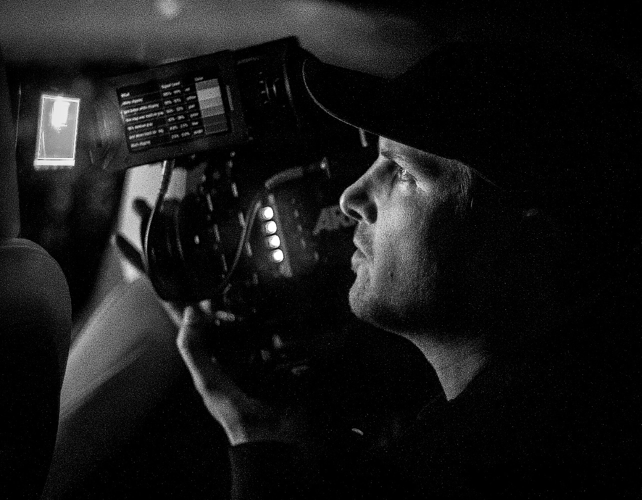 Rob Watt operating an ARRI Alexa Mini LF camera on set, black and white