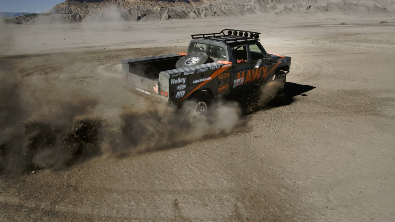 Aerial view of the HAWX off-road truck throwing up dust in the desert badlands, from the HAWX Work Wear commercial
